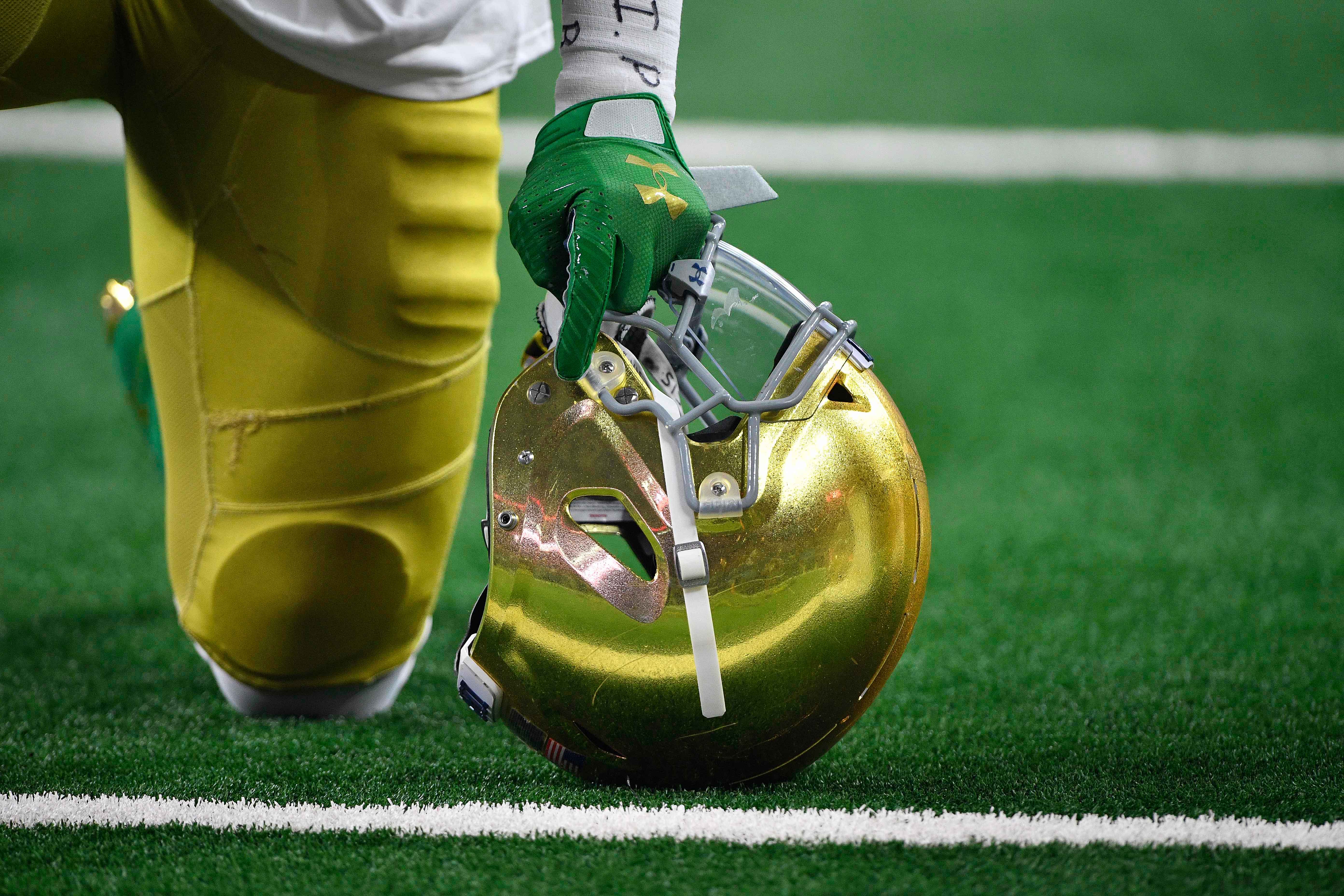 Notre Dame player kneeling before game