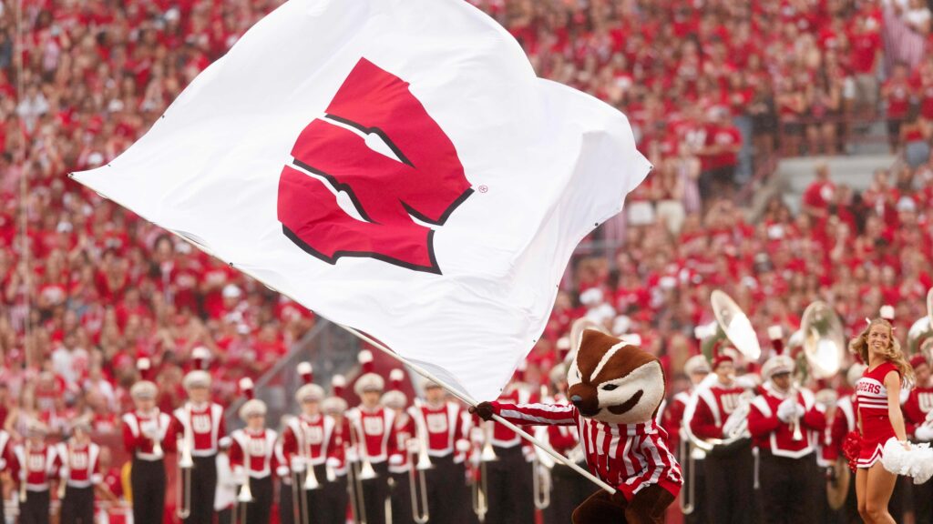 Wisconsin mascot Bucky with a flag.