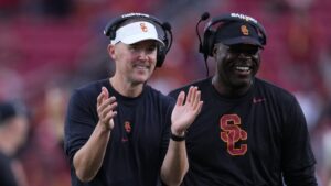 Lincoln Riley is shown coaching.