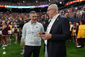 Big Ten and SEC commissioners shown before game.