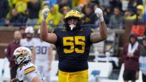 Michigan DL Mason Graham celebrates a key tackle.