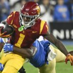 Zachariah Branch catches a pass in the USC-UCLA game.