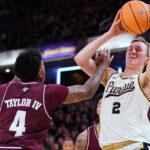 Texas A&M's Wade Taylor IV guards Purdue's Fletcher Loyer.