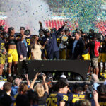 Michigan head coach Sherrone Moore celebrates a ReliaQuest Bowl win.