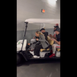 Ryan Day and Ohio State players in a golf cart.