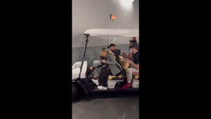 Ryan Day and Ohio State players in a golf cart.