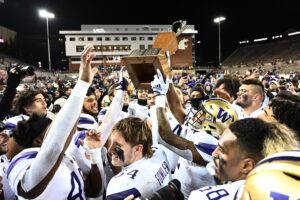 Washington players celebrate with the Apple Cup.
