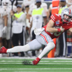 Ohio State QB Will Howard falls.