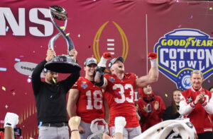 Ohio State players celebrate with Cotton Bowl trophy.