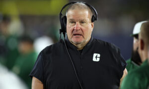 Biff Poggi coaches a game.