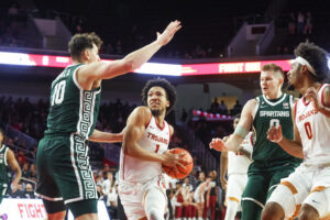 Michigan State and USC players in action.