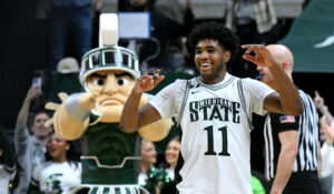 MSU's Jase Richardson with Sparty in the background.