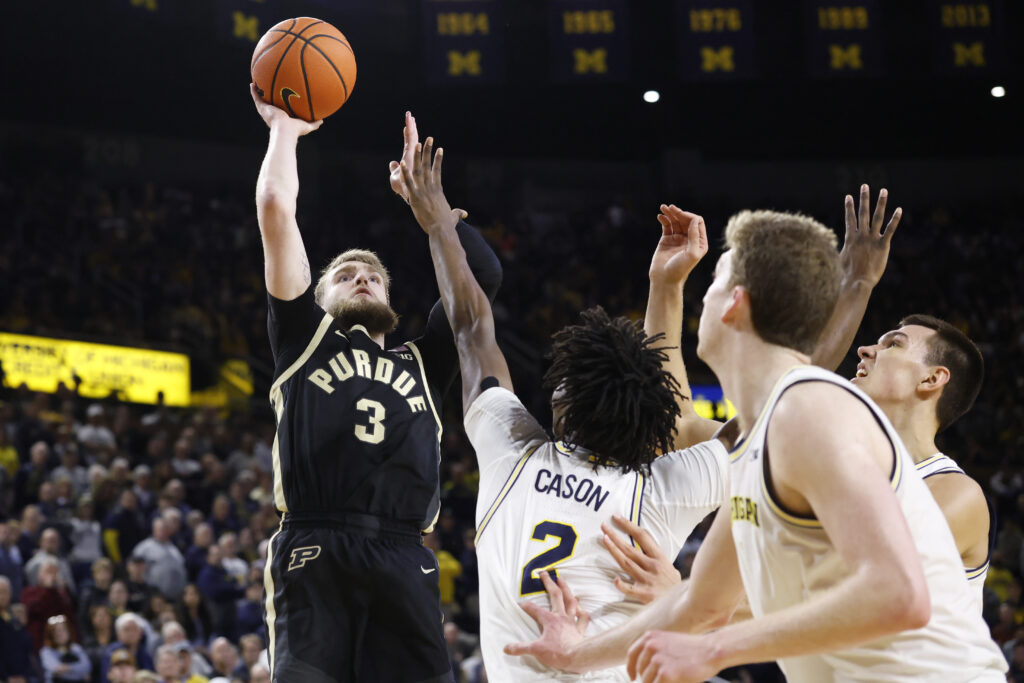Purdue and Michigan players in action.