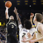 Purdue and Michigan players in action.