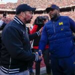 Ryan Day and Sherrone Moore shake hands.