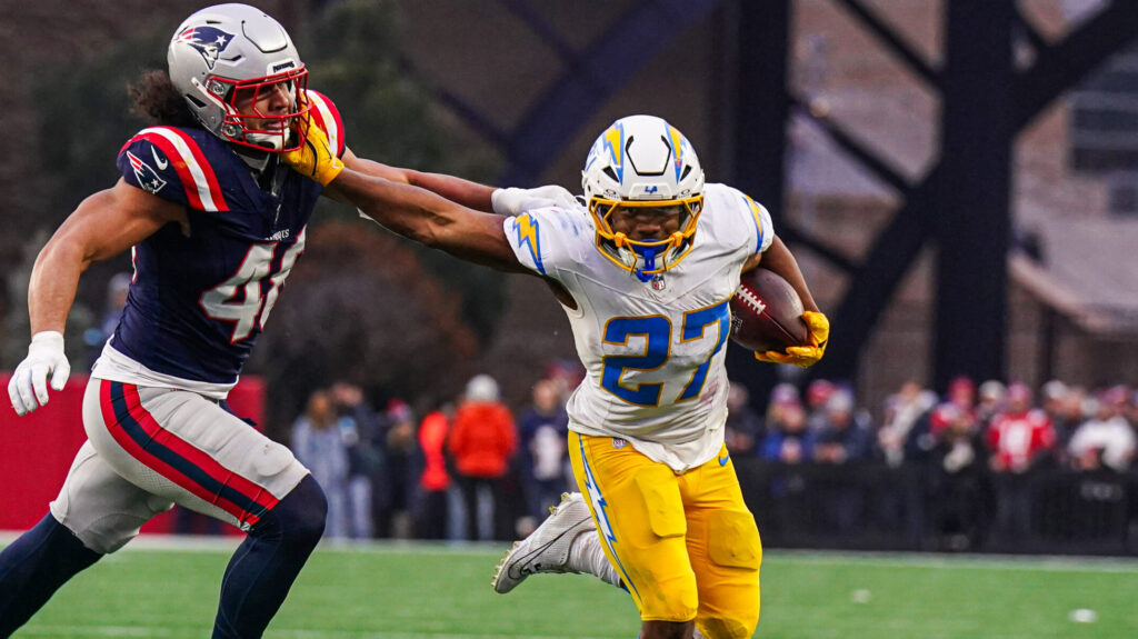 Los Angeles Chargers RB JK Dobbins delivers a stiff arm.