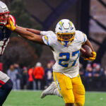Los Angeles Chargers RB JK Dobbins delivers a stiff arm.