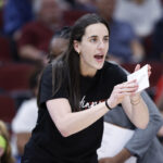 Indiana Fever star Caitlin Clark cheers her team on.