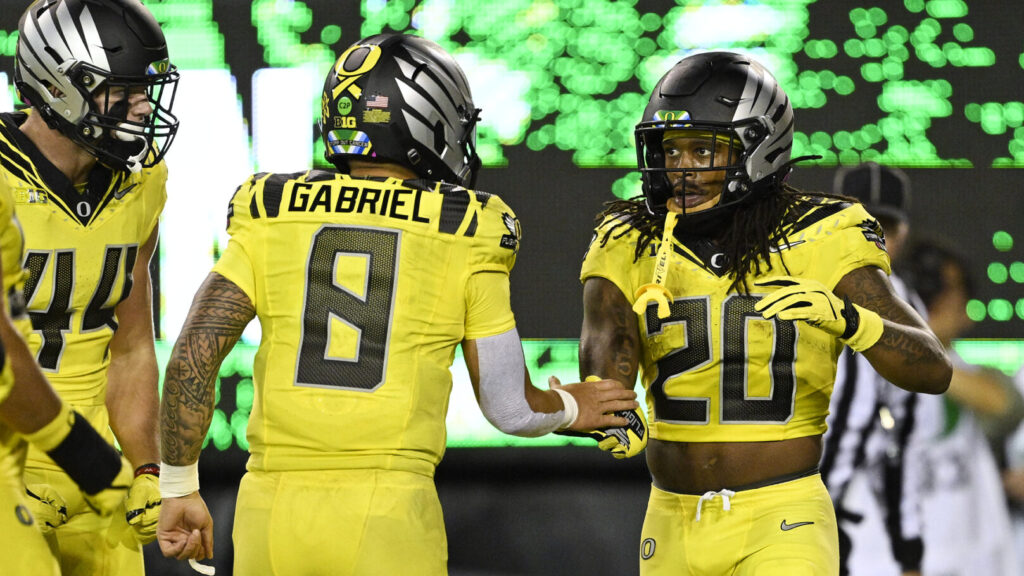 Oregon stars Jordan James and Dillon Gabriel celebrate.