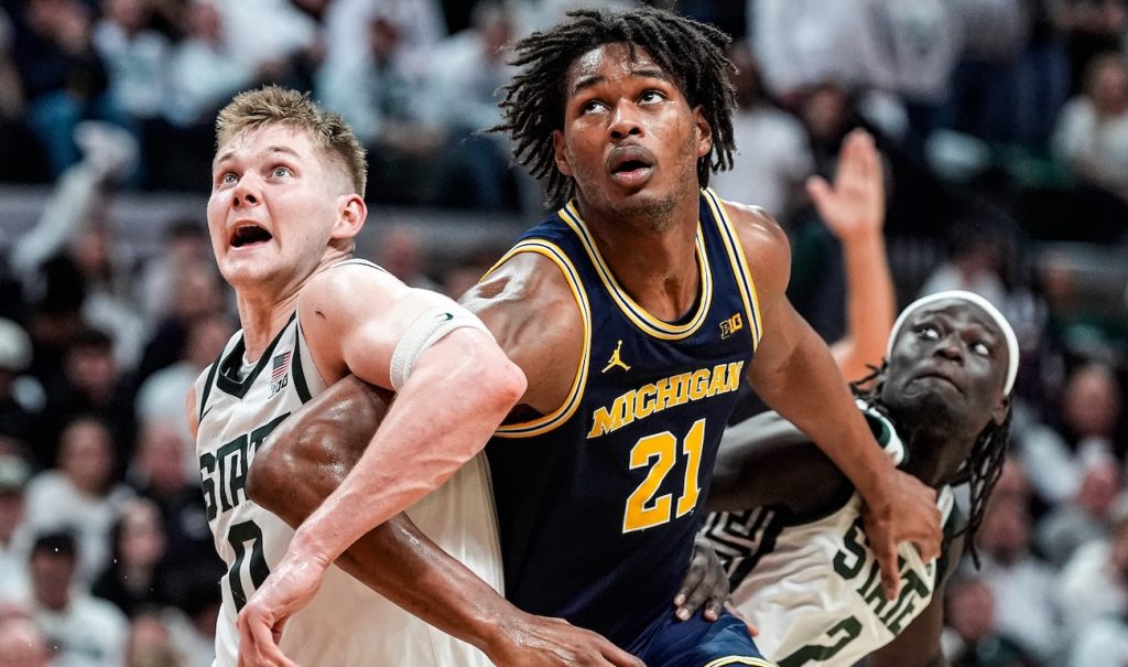 Michigan and Michigan State players battle for a rebound.
