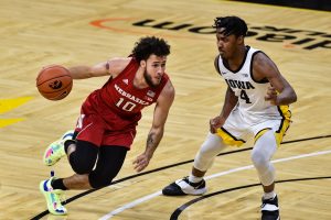 Nebraska Cornhuskers guard Kobe Webster controls the ball as Iowa Hawkeyes guard Ahron Ulis