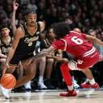 C.J. Cox (0) drives past Indiana Hoosiers guard Tayton Conerway