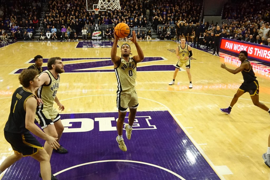 C.J. Cox (0) shoots the ball against the Northwestern Wildcats