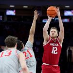 Tucker Devries shoots the ball as Ohio State Buckeyes forward Devin Royal defends