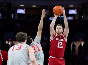 Tucker Devries shoots the ball as Ohio State Buckeyes forward Devin Royal defends