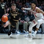 Braden Smith drives to the basket around Wisconsin Badgers guard Nick Boyd
