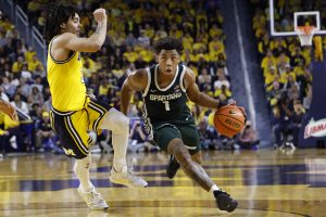 Jeremy Fears Jr. dribbles defended by Michigan Wolverines guard Elliot Cadeau