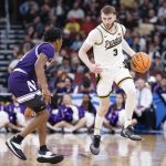 Braden Smith brings the ball up court against Northwestern Wildcats guard Jayden Reid
