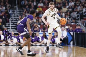Braden Smith brings the ball up court against Northwestern Wildcats guard Jayden Reid