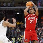 Devin Royal shoots against Michigan Wolverines guard Elliot Cadeau.