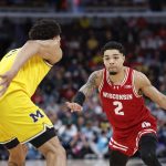Nick Boyd drives to the basket against the Michigan Wolverines.