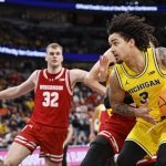 Elliot Cadeau drives to the basket against the Wisconsin Badgers.