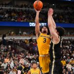 Elliot Cadeau takes a shot over guard Omer Mayer.