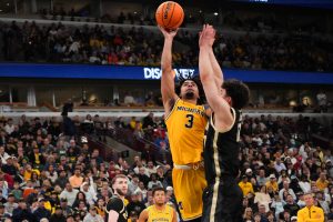 Elliot Cadeau takes a shot over guard Omer Mayer.