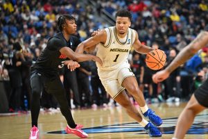 Trey McKenney dribbles the ball against Howard Bison guard BJ Powell.