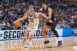 Michigan State Spartans center Carson Cooper drives to the basket in the second half against the Louisville Cardinals.