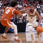 Purdue Boilermakers guard C.J. Cox drives past Texas Longhorns guard Jordan Pope.