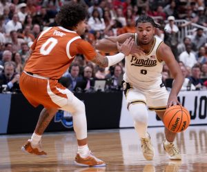 Purdue Boilermakers guard C.J. Cox drives past Texas Longhorns guard Jordan Pope.