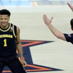 Michigan's Trey McKenney celebrates a 3-pointer against Arizona.