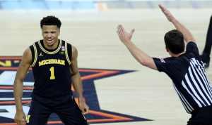 Michigan's Trey McKenney celebrates a 3-pointer against Arizona.
